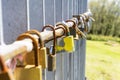 Old rusty love padlocks hanging on railing outdoors Royalty Free Stock Photo