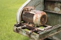 Old rusty machine in green grass background Royalty Free Stock Photo