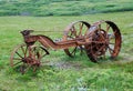 Old rusty machine in the green meadow Royalty Free Stock Photo