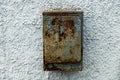Old rusty mailbox hanging on stone texture wall Royalty Free Stock Photo