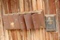 Old rusty mailbox on a wooden fence