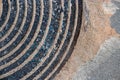 Old Rusty Manhole Cover Circular Pattern With Sand Or Dirt On The Edge Royalty Free Stock Photo