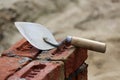 Old rusty Masonry Trowel Mason tool on bricks work under construction