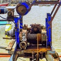 Old rusty mechanism of old winch rusty machinery at a quayside Royalty Free Stock Photo