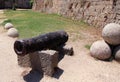 Old rusty medieval cannon in the drained moat surrounding the walls of Rhodes Fortress and Rhodes Old Town