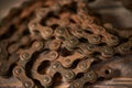 Old rusty bicycle chain on a wooden background Royalty Free Stock Photo