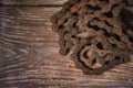 Old rusty bicycle chain on a wooden background Royalty Free Stock Photo