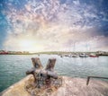 Old rusty metal bollard in the Dingle harbour at sunset