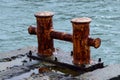 Old rusty metal bollard pier - device for yacht mooring Royalty Free Stock Photo