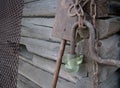 Old rusty metal chain, grid, shovel and lantern on the wooden logs background Royalty Free Stock Photo