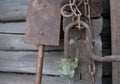 Old rusty metal chain, shovel, glass lantern on the wood logs background Royalty Free Stock Photo