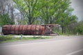 Old rusty metal construction near the road. Abandoned tank. Crisis concept Royalty Free Stock Photo