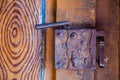 old rusty metal door lock. Dilapidated wooden door. The entrance to the ancient Catholic temple. Keyhole close-up Royalty Free Stock Photo