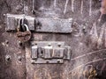Old grungy metal door with a padlock and latch Royalty Free Stock Photo