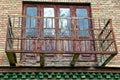 The old rusty metal frame of the balcony on the wall of the house Royalty Free Stock Photo