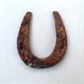 Old rusty metal horseshoe isolated on white background, top view. Royalty Free Stock Photo