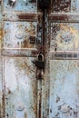 Old rusty metal lock and keyhole on a old turquoise metal rusty door as a beautiful vintage background Royalty Free Stock Photo