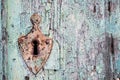 Old rusty metal lock and keyhole on a old turquoise wooden door