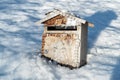 Old rusty metal Mailbox on the snow Royalty Free Stock Photo