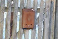 Old rusty metal mailbox on a wooden fence Royalty Free Stock Photo