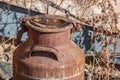 Old rusty metal milk jug in countryside Royalty Free Stock Photo
