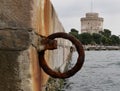 An old rusty metal mooring ring on the mooring wall on a sunny summer day. A device for holding sea vessels in port. heavily Royalty Free Stock Photo