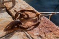 Old rusty metal mooring ring on an old stone pier, metal corrosion Royalty Free Stock Photo