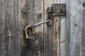 old rusty metal padlock on an old wooden door Royalty Free Stock Photo
