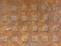 Old rusty metal plate with a pattern of square knobs. Royalty Free Stock Photo