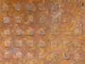 Old rusty metal plate with a pattern of square knobs. Royalty Free Stock Photo