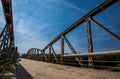 Rusty metal railings on the bridge over the river on sunny d Royalty Free Stock Photo