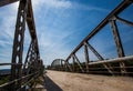 Old rusty metal railings on the bridge over the river on warm sunny day Royalty Free Stock Photo