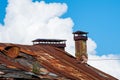 Old rusty metal roof with brick chimney Royalty Free Stock Photo