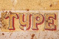 Old rusty metal sign with the word type