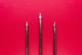 Old, rusty and metal trident with three spikes on red backgroun
