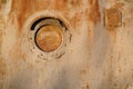 Old rusty metal wall with a small round window Royalty Free Stock Photo