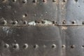 Old and rusty metal wall surface with big rivets Royalty Free Stock Photo