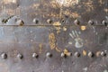 Old and rusty metal wall surface with big rivets Royalty Free Stock Photo