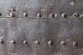 Old and rusty metal wall surface with big rivets Royalty Free Stock Photo