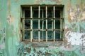 Old rusty metal window bars on a decaying green painted wall Royalty Free Stock Photo