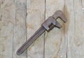 Old and rusty metal wrench on wooden surface Royalty Free Stock Photo