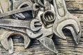 Old rusty metallic spanners on wooden table Royalty Free Stock Photo