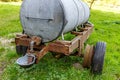 Old rusty mobile water tank with its cattle waterer on an agricultural plot