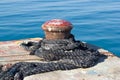 Old rusty mooring bollard on pier Royalty Free Stock Photo