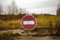 Old rusty no entry sign on an old abandoned road in a field Royalty Free Stock Photo