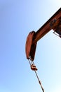 Old rusty oil derrick in sunlight with blue sky Royalty Free Stock Photo