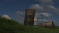 Old rusty oil tank on a green grass nature scene