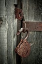 Old rusty opened lock without key. Vintage wooden door, close up concept photo