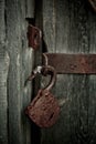 Old rusty opened lock without key. Vintage wooden door, close up concept photo Royalty Free Stock Photo