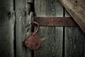 Old rusty opened lock without key. Vintage wooden door, close up concept photo